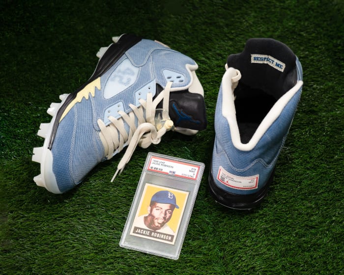 View of blue cleats and Jackie Robinson baseball card.